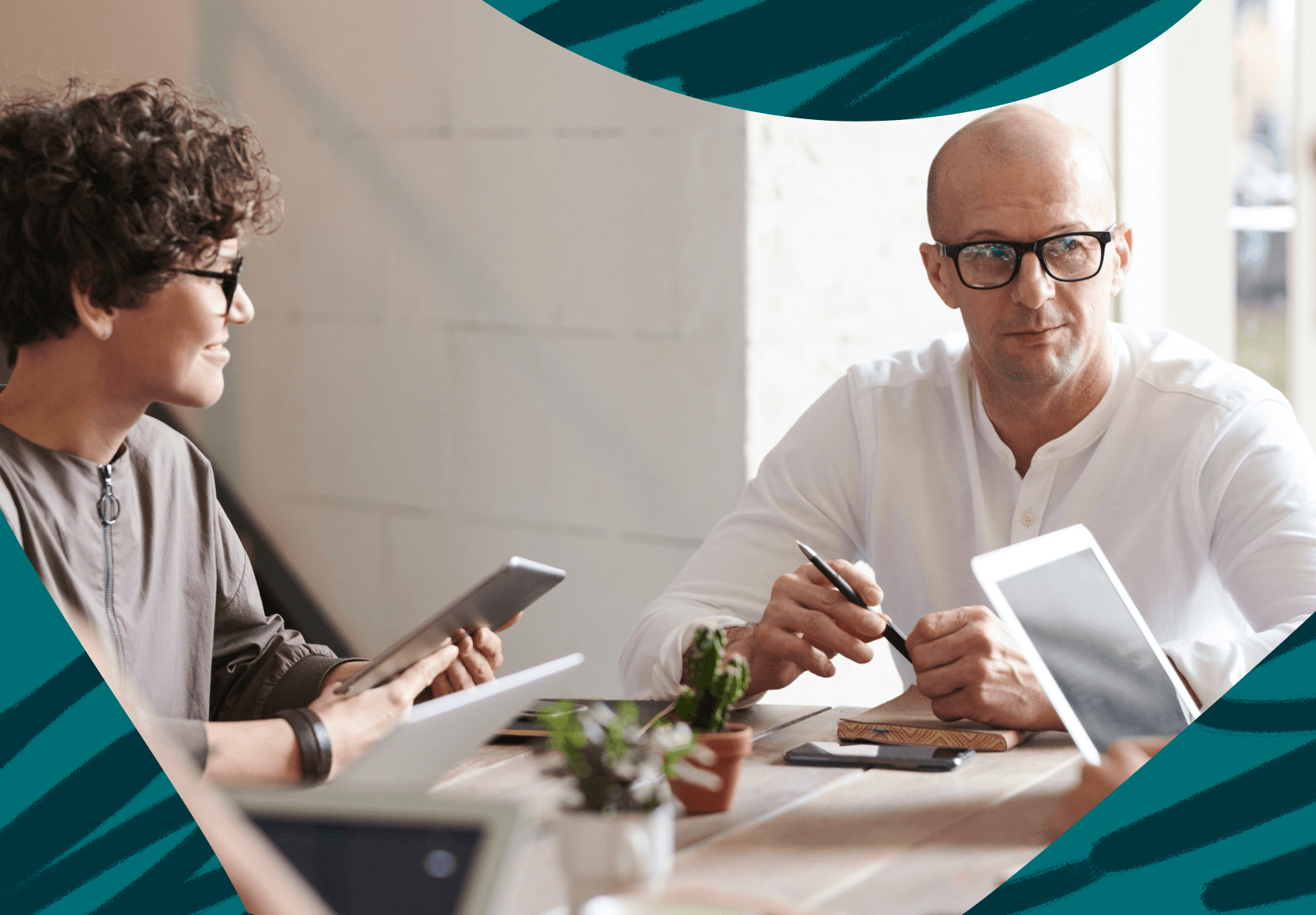 Woman and man sitting at an office desk having a meeting