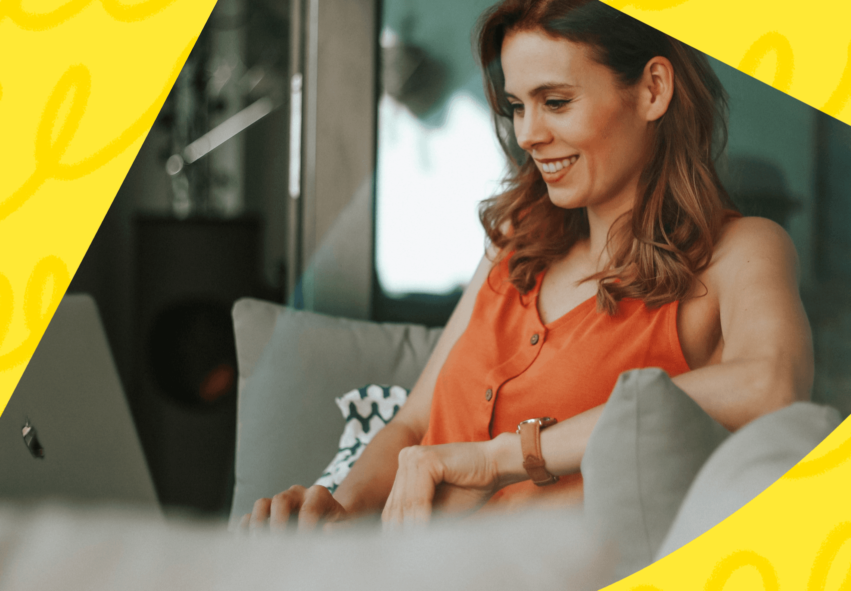 Woman sitting on couch looking at her laptop