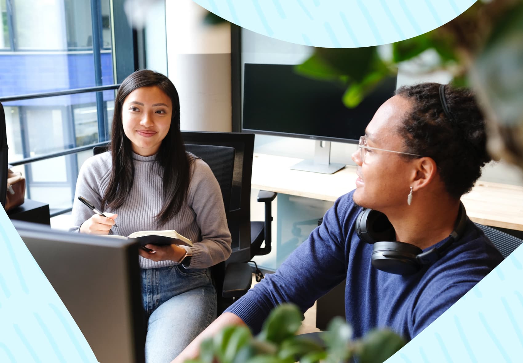 Two people sitting in an office during a meeting
