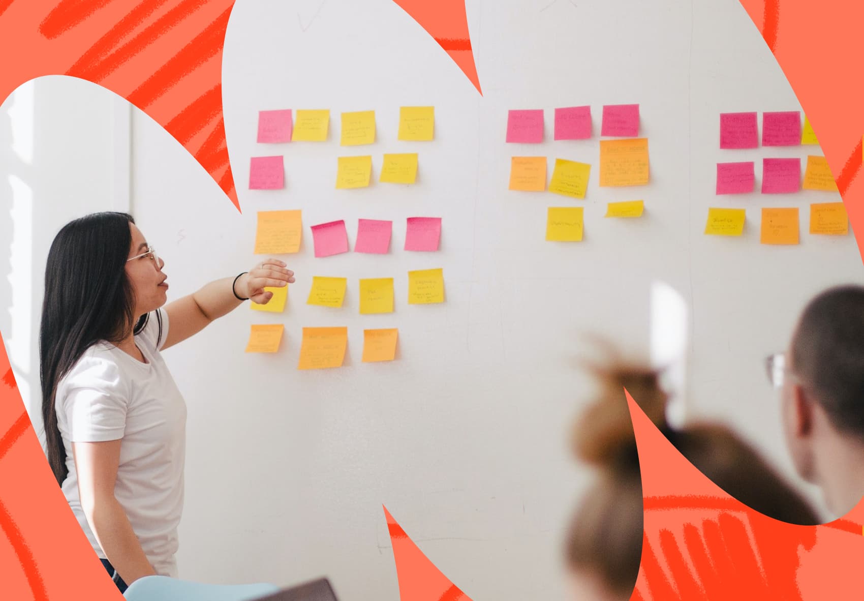 Woman standing in front of a whiteboard that has post-it notes