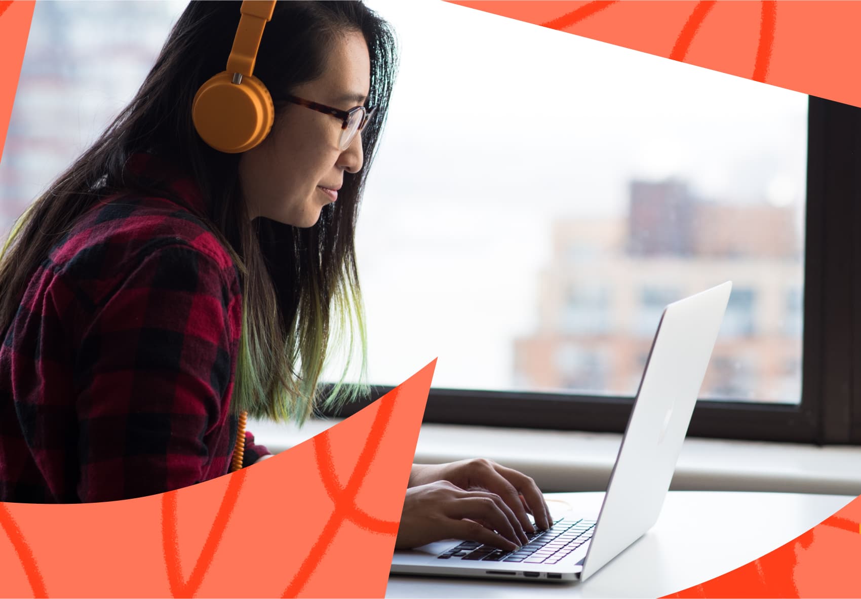 Smiling woman sitting in front of a laptop