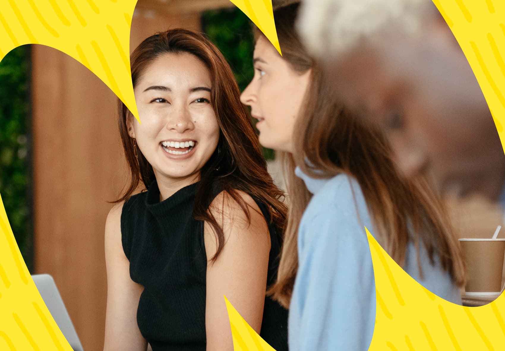 One office worker smiling and talking to another office worker