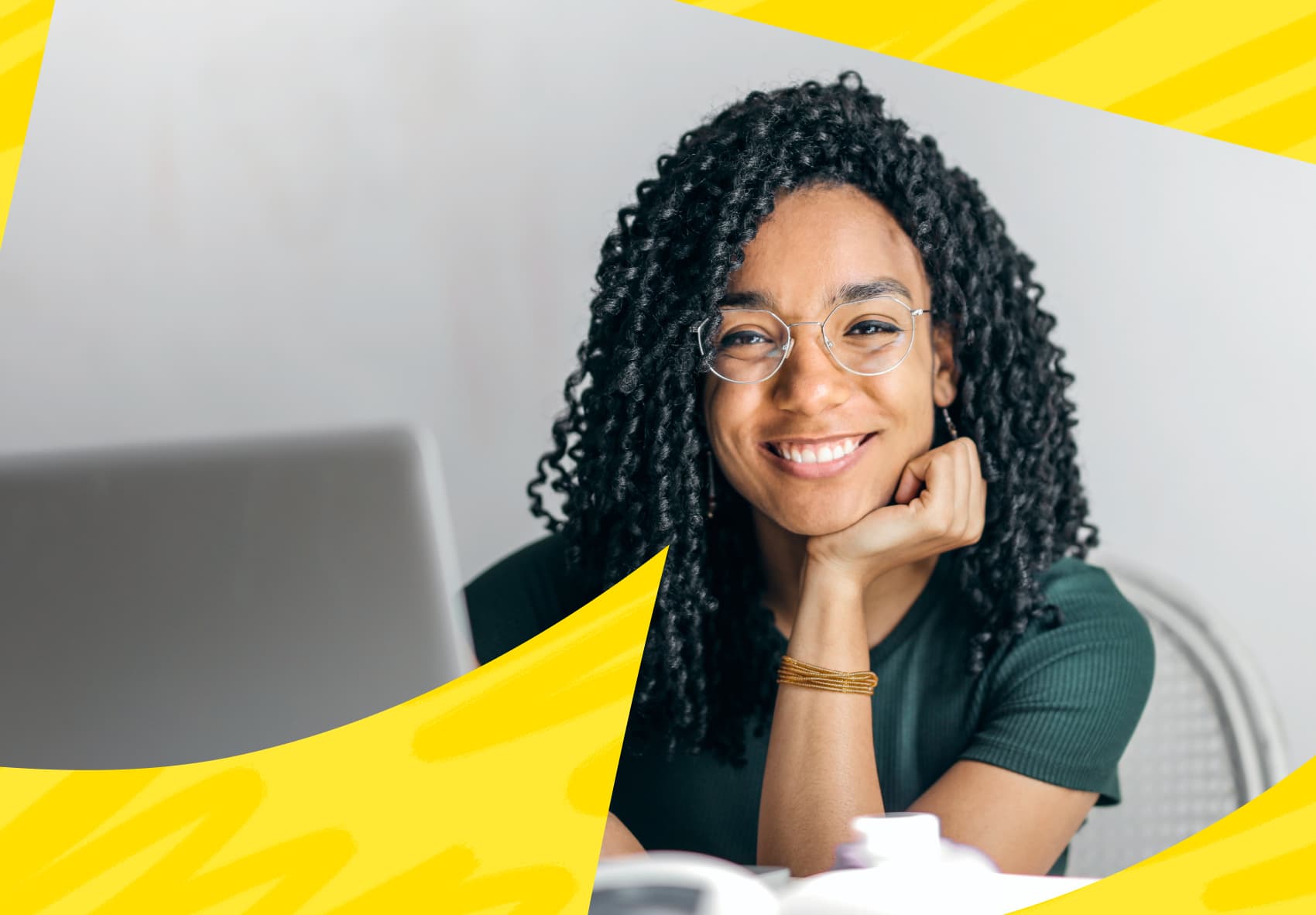 Smiling woman sitting in front of a laptop