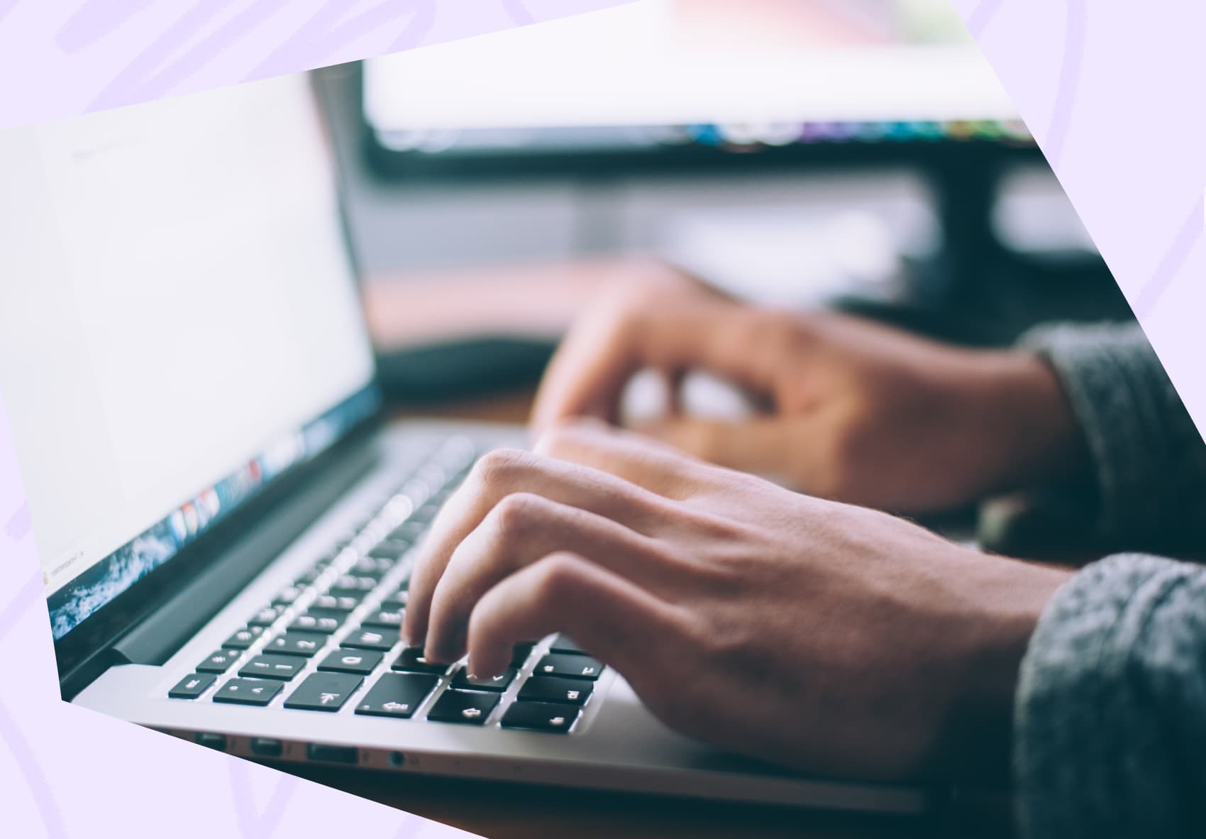 Two hands typing on the keyboard of a laptop