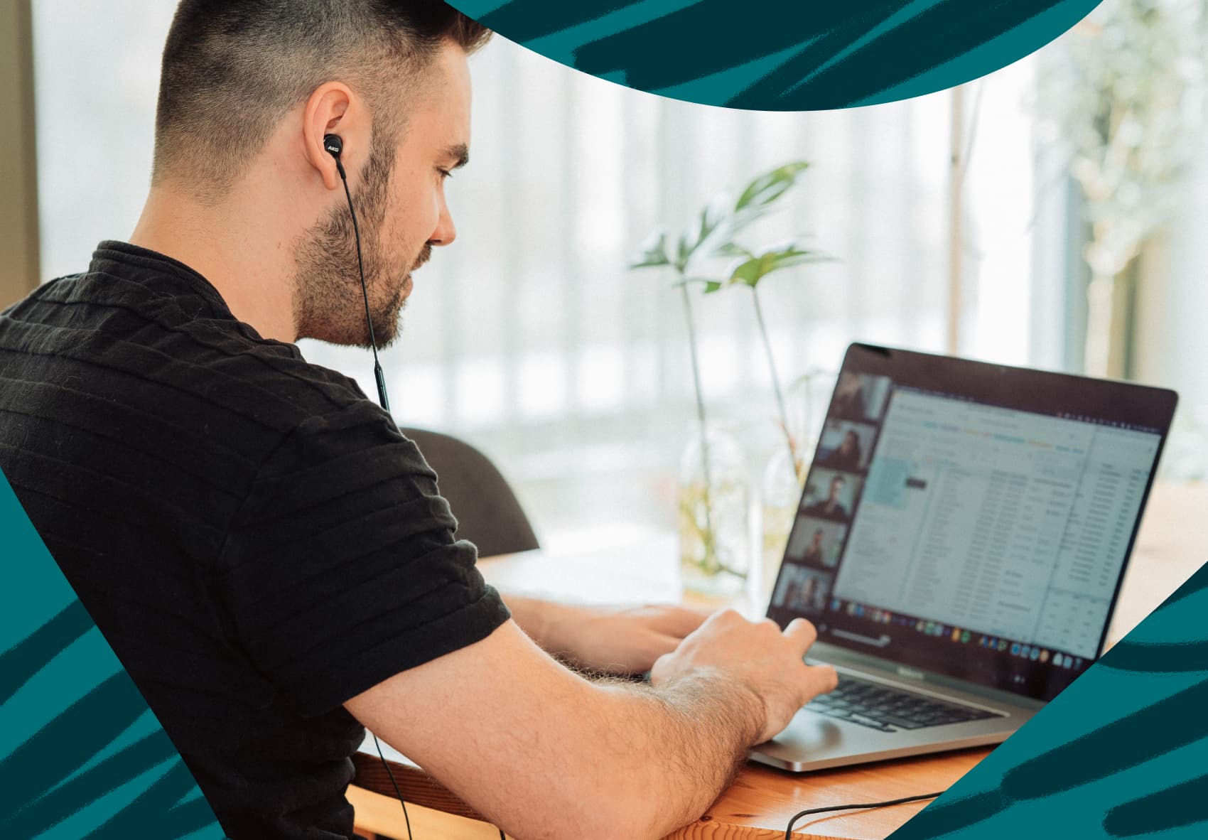 Man sitting at desk on a Zoom meeting with earphones in.