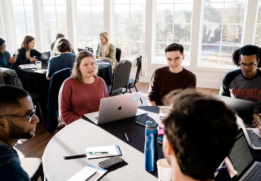 Group of YNAB workers sitting around a table