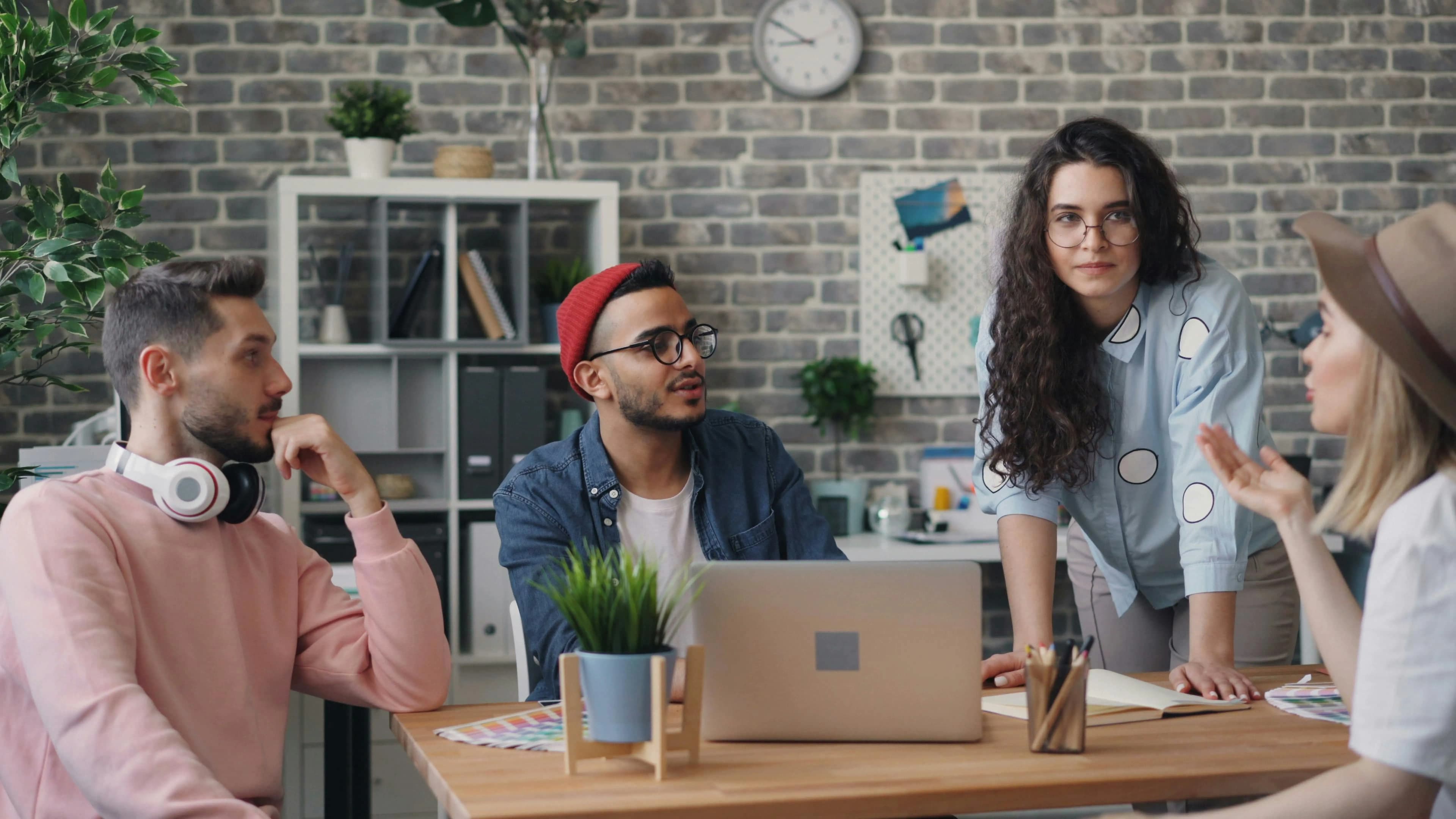 A group of work colleagues chatting and sitting around a table